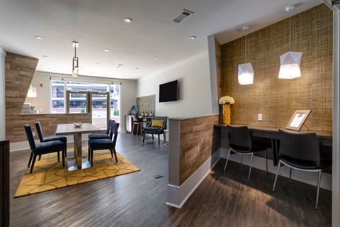 A modern dining room with a wooden table and chairs.