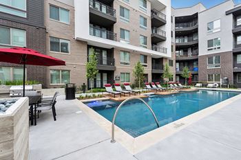 Sparkling Swimming Pool and Lounge Area at Night at Berkshire Auburn, Texas, 75248