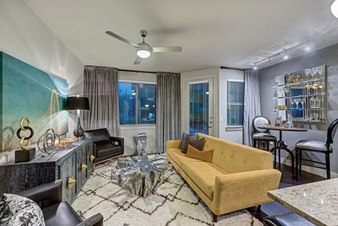 a living room filled with furniture and a ceiling fan