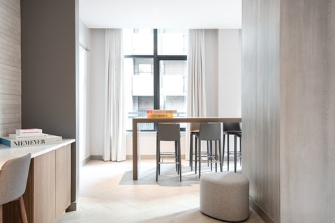 A modern dining room with a wooden table and chairs.