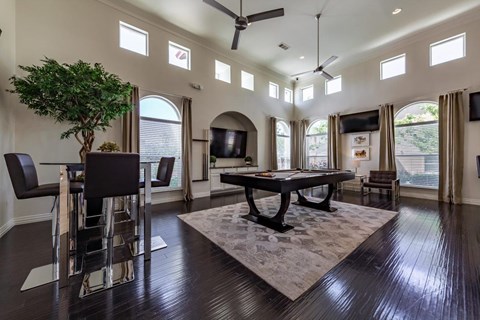 A living room with a black table and chairs.