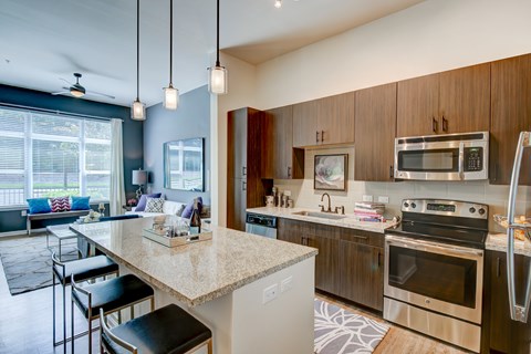 A kitchen with a bar area and a dining area.