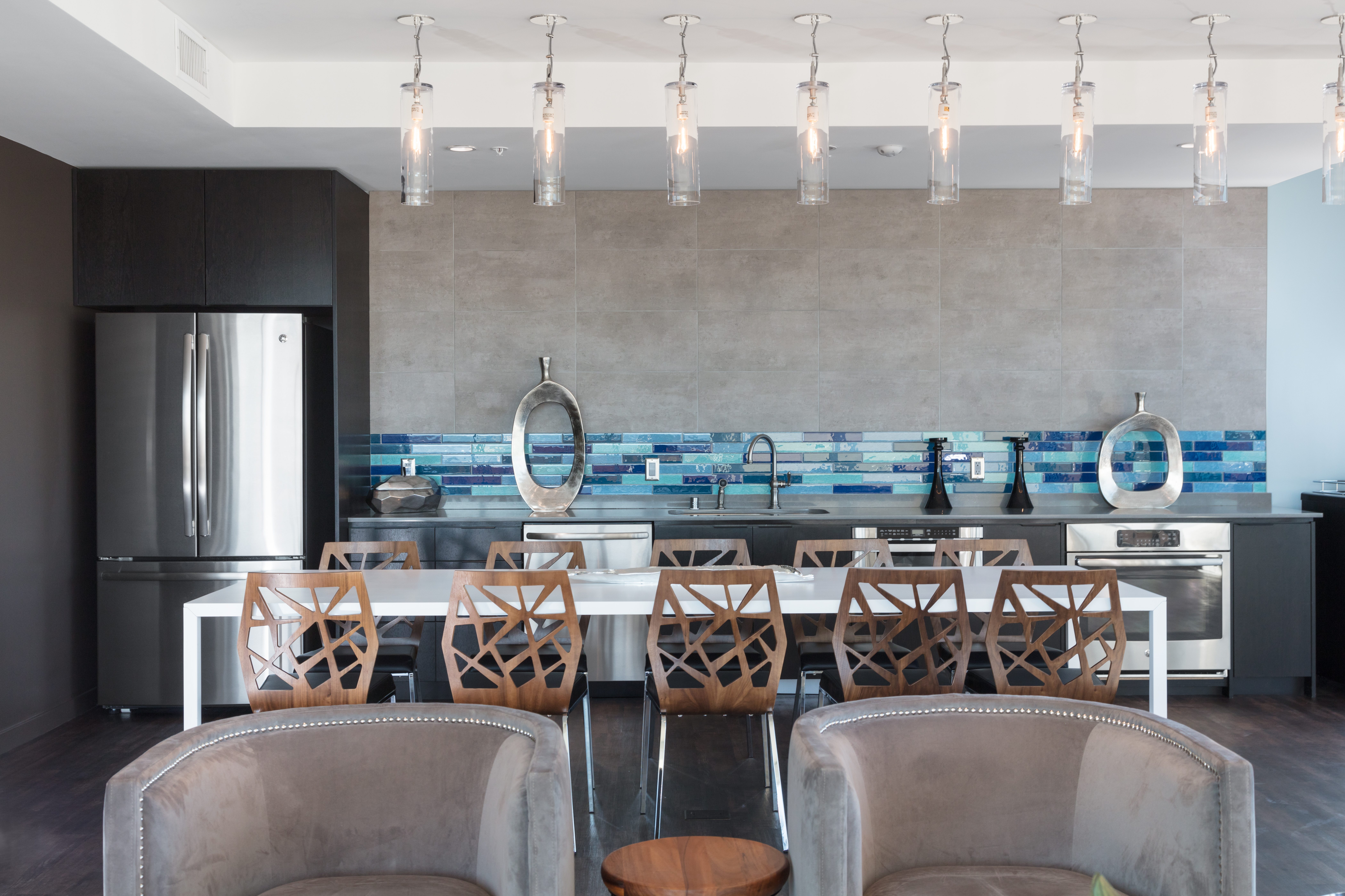 A modern kitchen with a dining table and chairs.