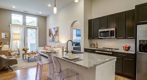 a kitchen and living room with a counter top