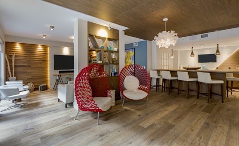 A modern living room with a red chair and white chairs.