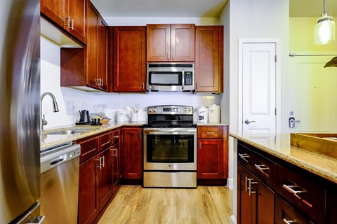 A kitchen with wooden cabinets and stainless steel appliances.