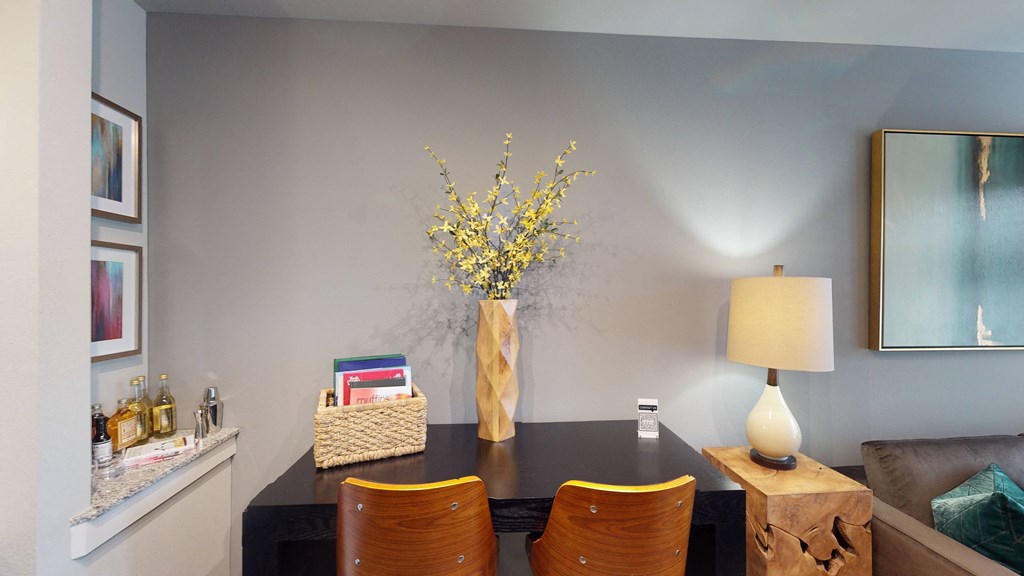a dining room table with a vase of flowers on top of it