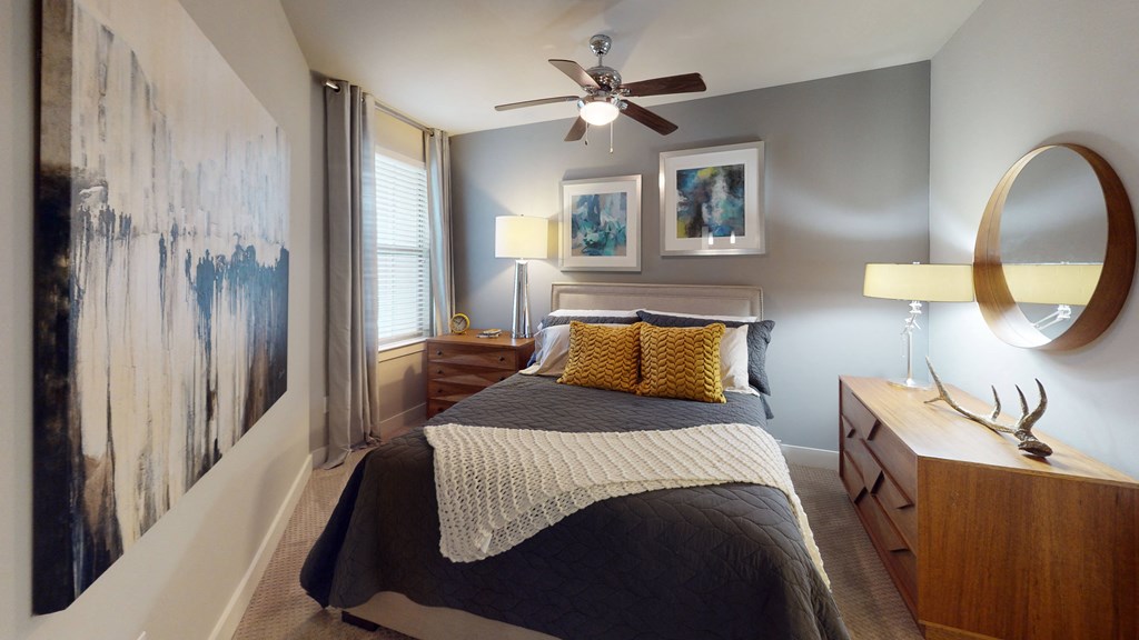a bedroom with a bed and a ceiling fan