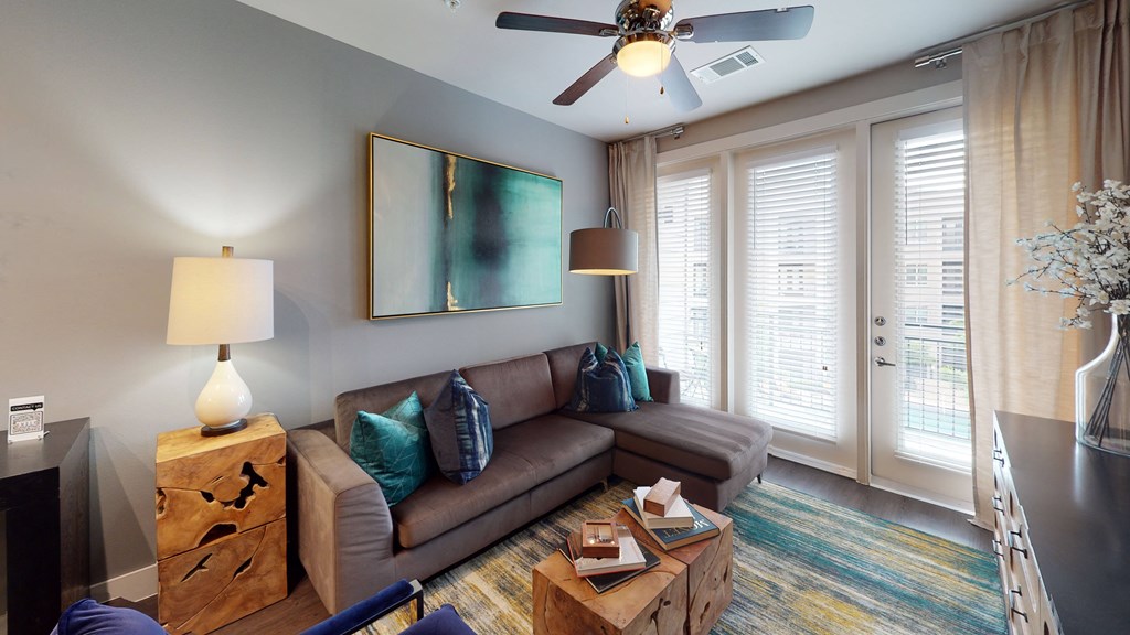 a living room filled with furniture and a ceiling fan