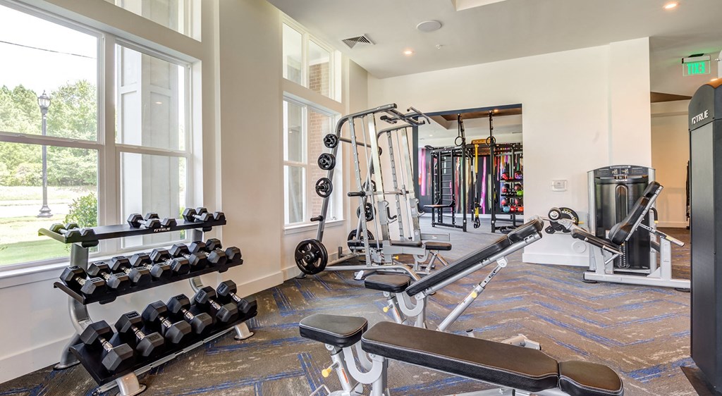 Fitness center with free weights and strength training at Berkshire Ballantyne apartments
