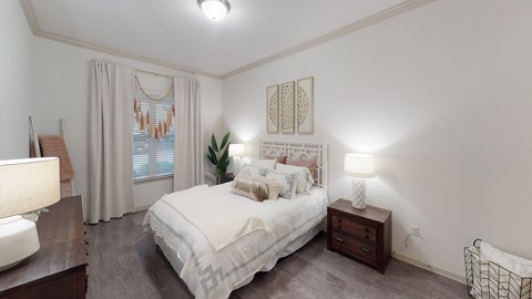a bedroom with a bed and two night stands