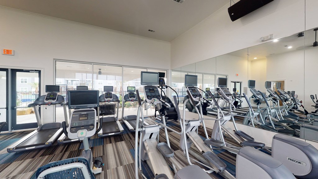 a room filled with lots of cardio equipment