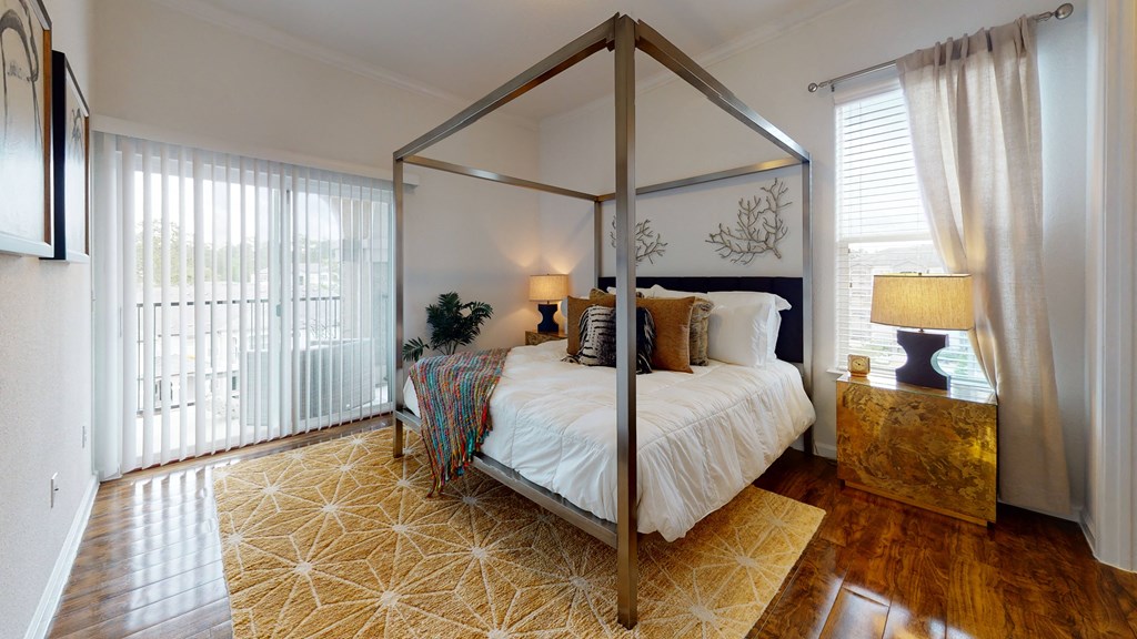 a bedroom with a bed and two windows