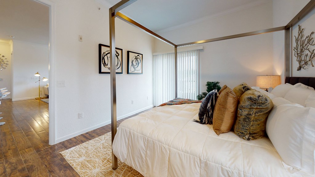 a bedroom with a large bed and a large window