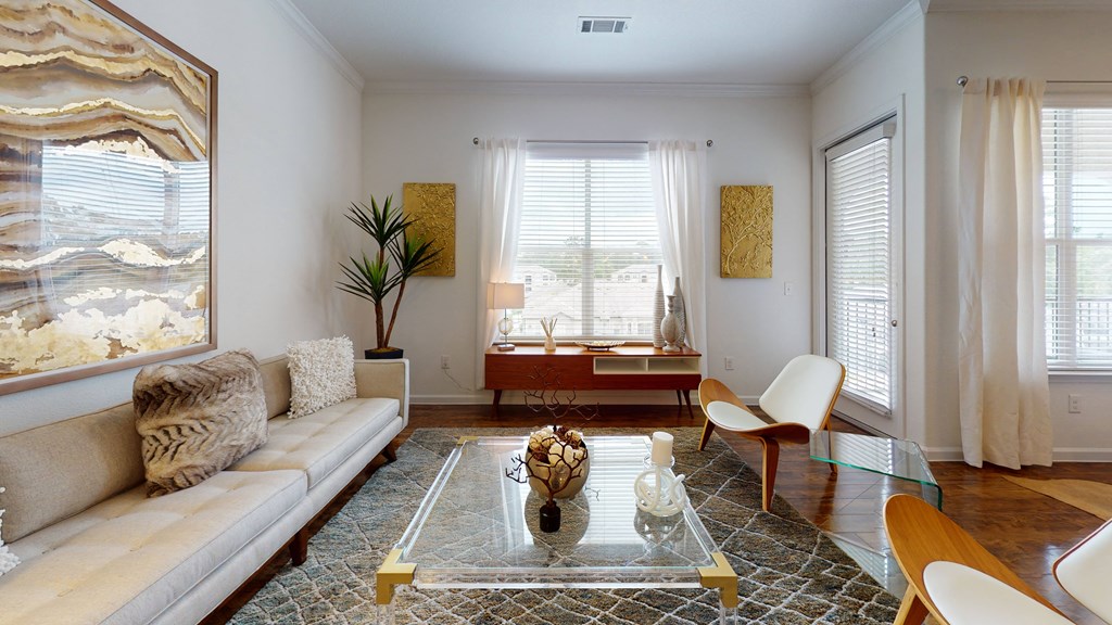 a living room with white walls and a glass coffee table