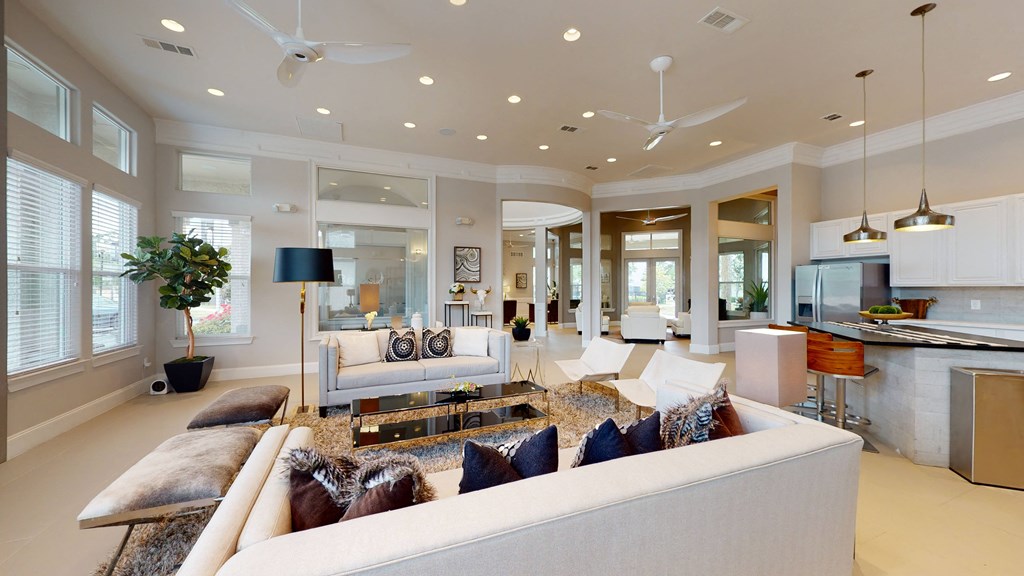 a living room filled with furniture and a large window