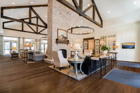 Clubhouse living room view of Alexander Village with round chandelier