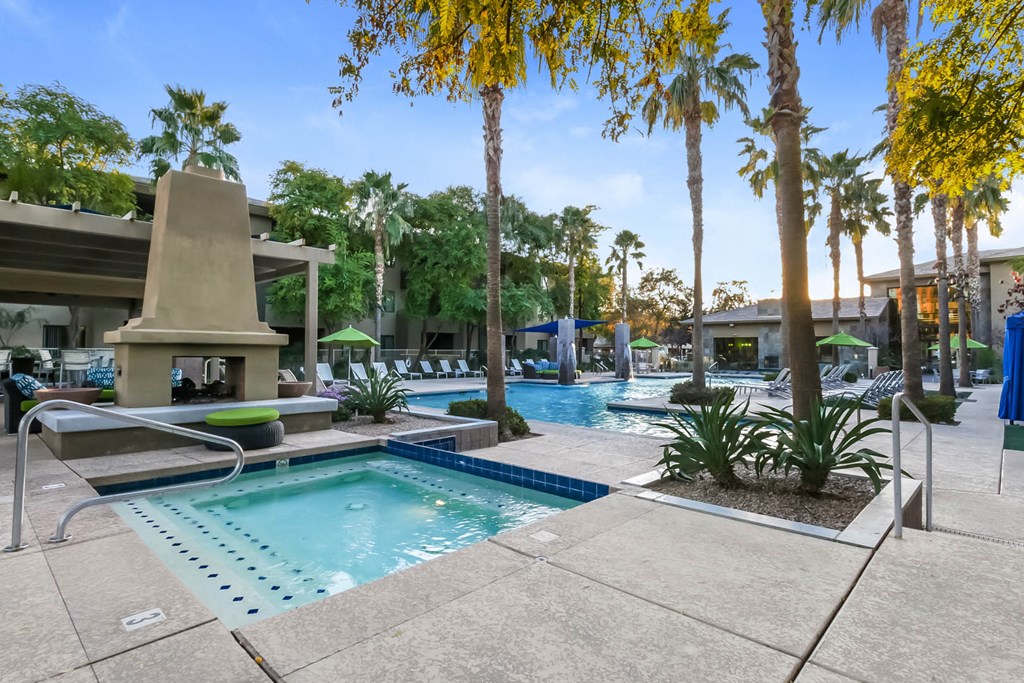 Exterior pool view with palm trees and fireplace