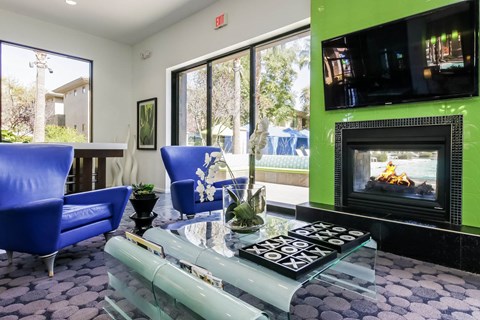 a living room with a fireplace and a glass table