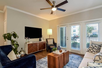 City North at Sunrise Ranch apartments living room with ceiling fan - Photo Gallery 11