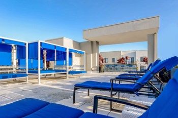 Pure Living apartments poolside lounging - Photo Gallery 5