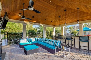 Grand at Cypress Cove apartments outdoor living area with comfortable seating - Photo Gallery 6