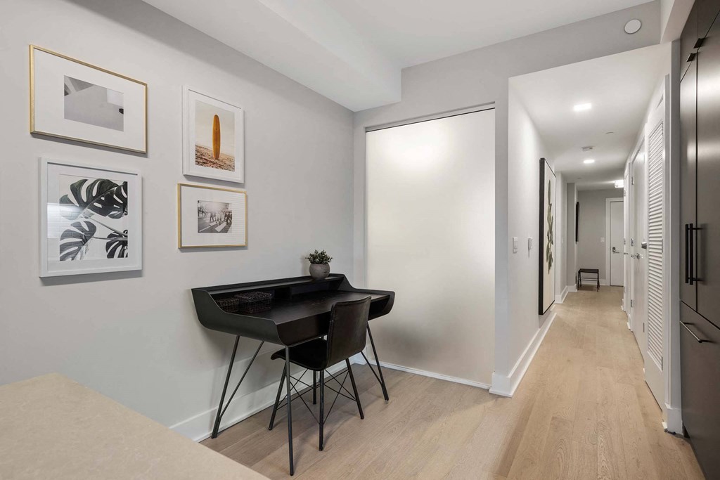a home office with a black desk and chair at Tribeca NOMA apartments