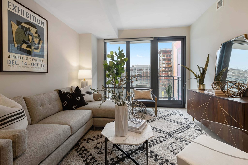 A living room with a large window with a view at Tribeca NOMA apartments