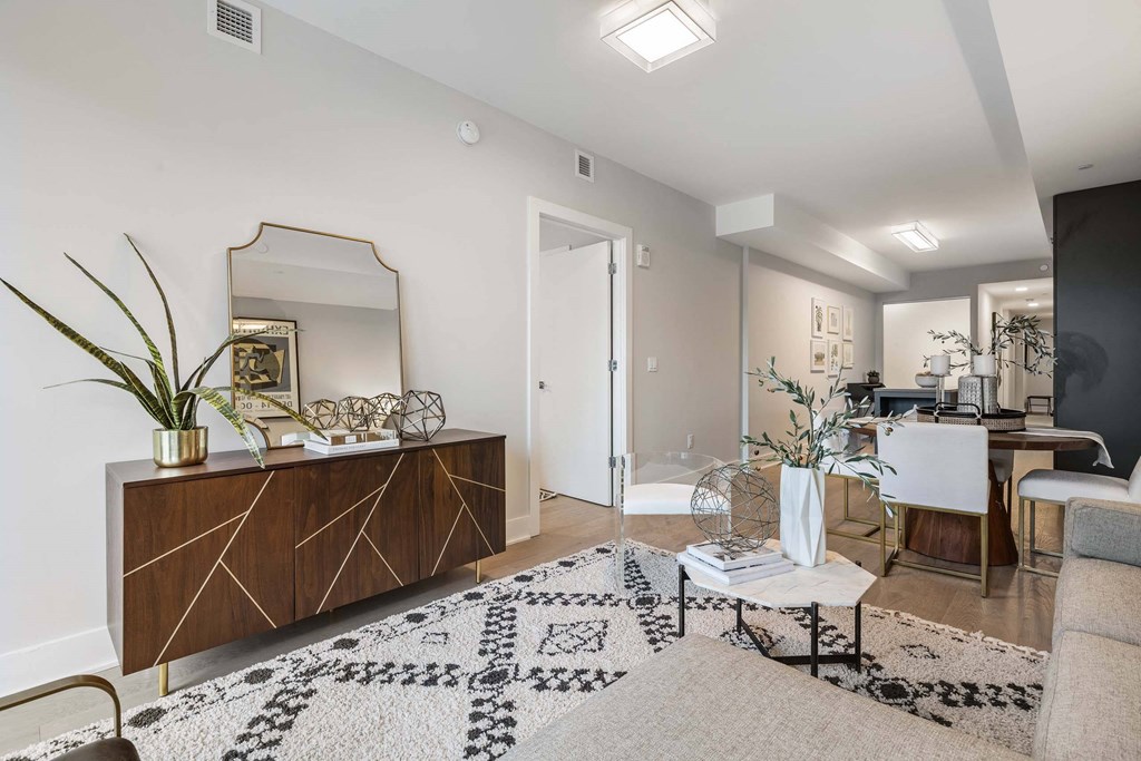 a living room with white walls and a mirror at Tribeca NOMA apartments
