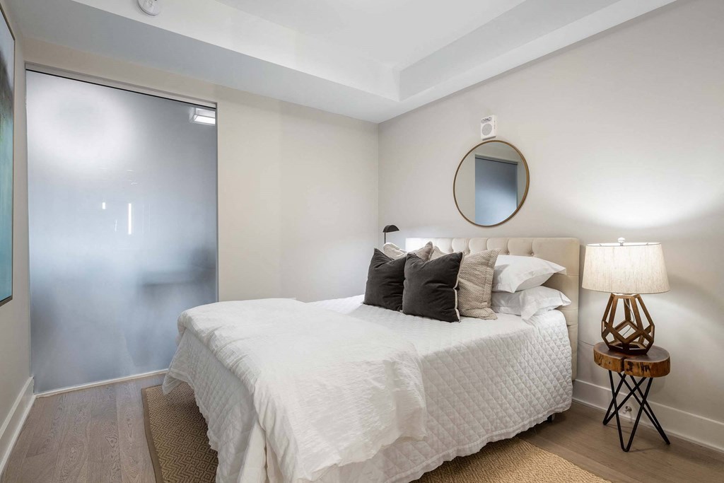 a bedroom with a sliding glass door at Tribeca NOMA apartments