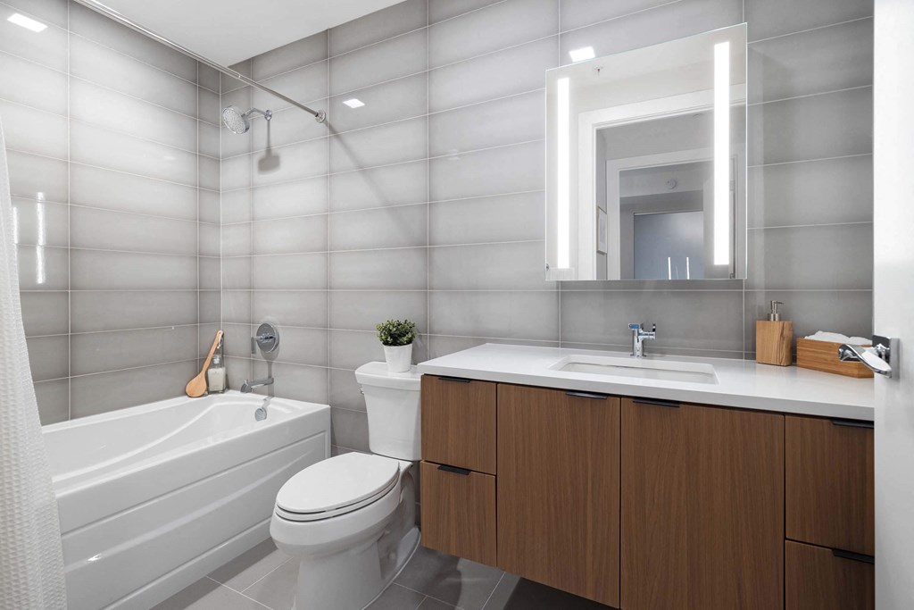 a bathroom with a toilet shower and sink at Tribeca NOMA apartments