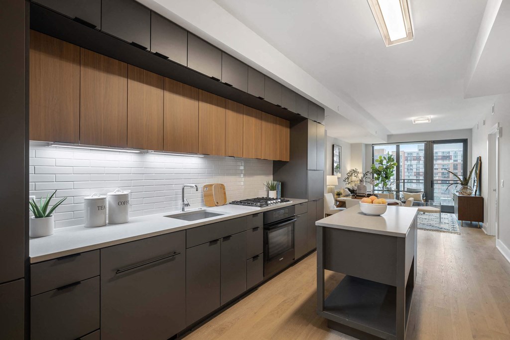 a kitchen with wooden cabinets and a white countertop in Tribeca NOMA apartments