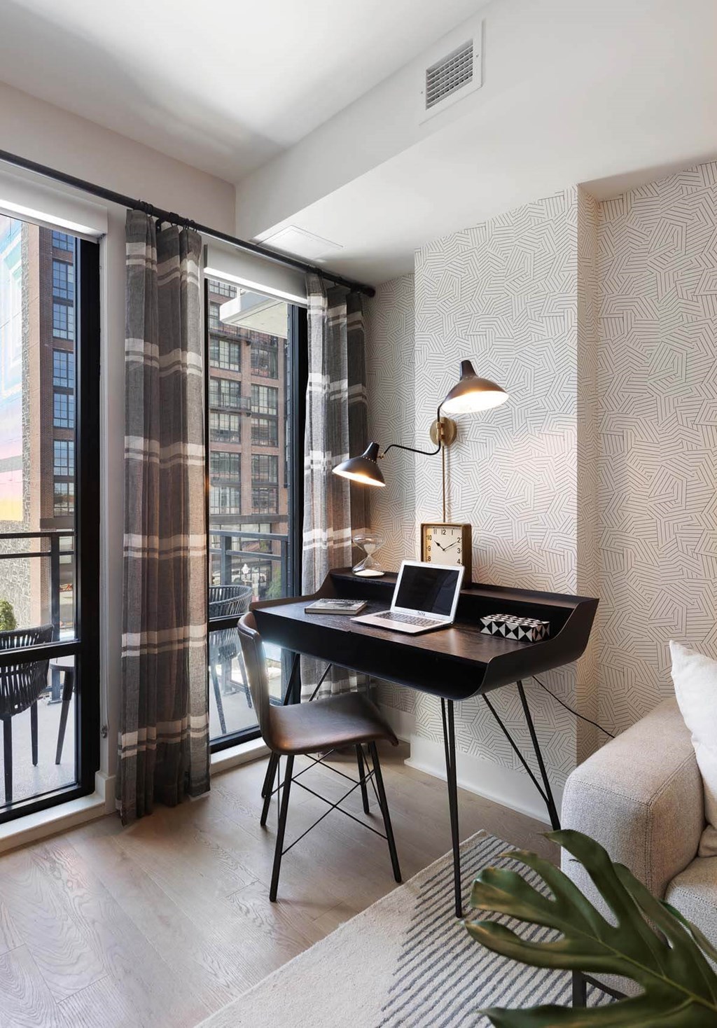 A work from home space with a desk and large window at Tribeca NOMA apartments