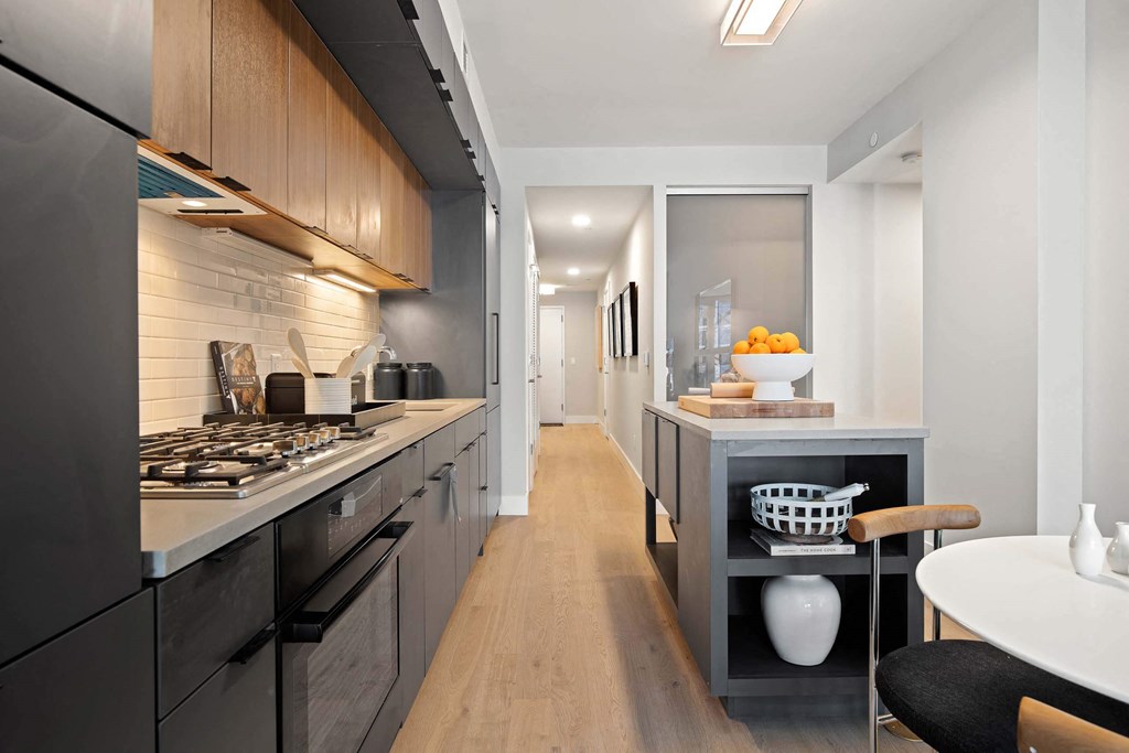 a kitchen with a long counter and a modern stove in Tribeca NOMA apartments