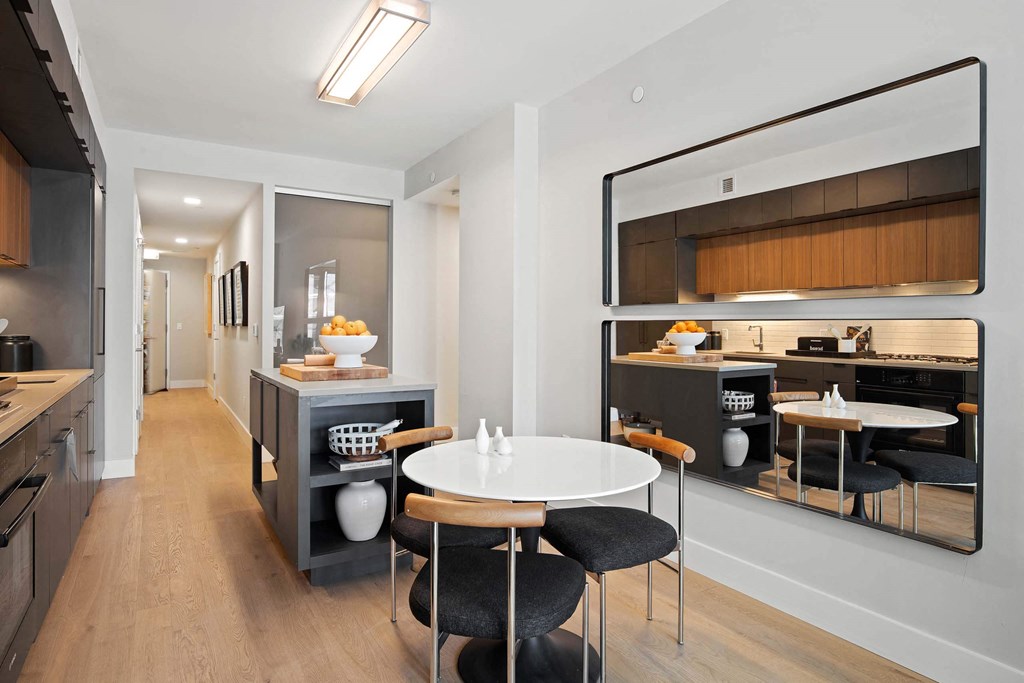 a kitchen and dining room with large wall mirrors at Tribeca NOMA apartments