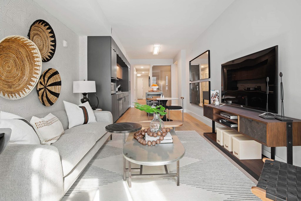 a living room with a couch table and TV at Tribeca NOMA apartments