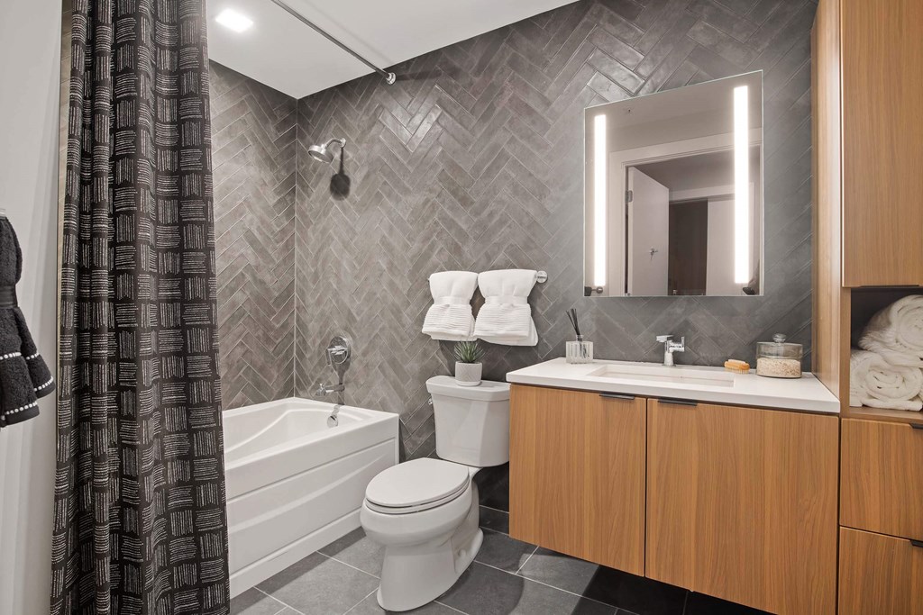 a bathroom with a sink toilet and a bath tub in Tribeca NOMA apartments
