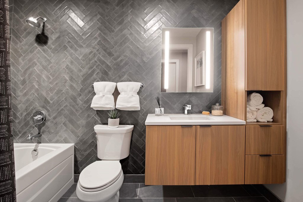 a bathroom with a toilet and a sink and a bath tub at Tribeca NOMA apartments