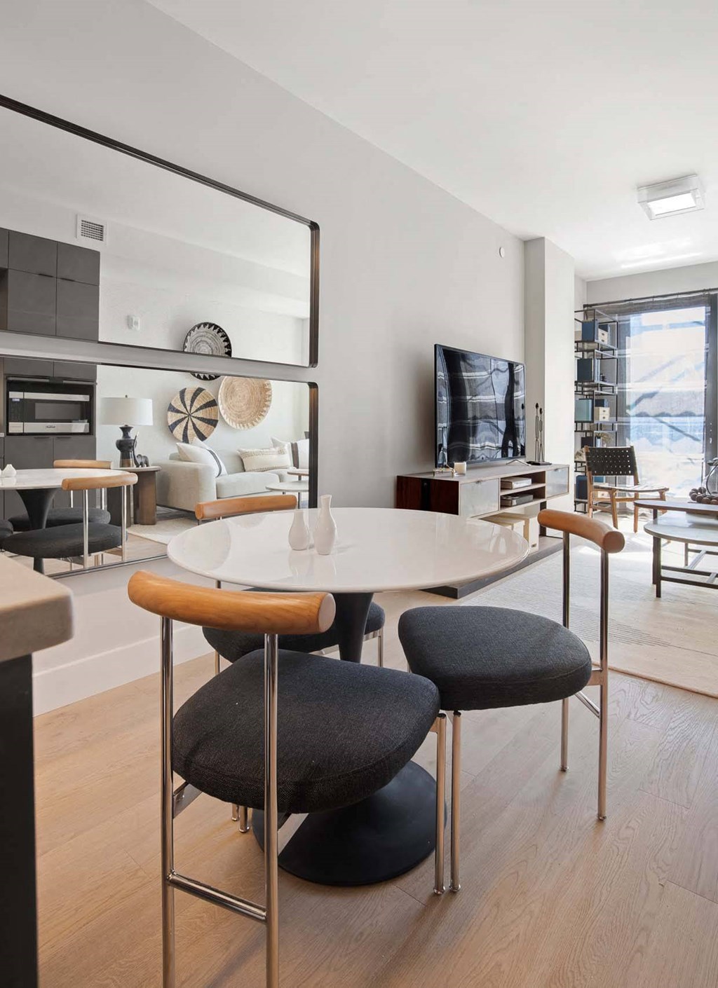 a dining room and living room with a table and chairs at Tribeca NOMA apartments