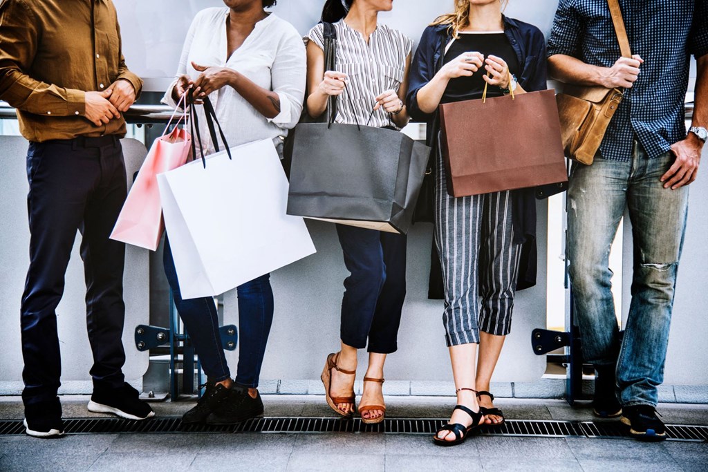 a group of people holding shopping bags