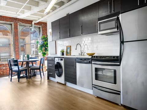 A modern kitchen with a dining table and chairs.