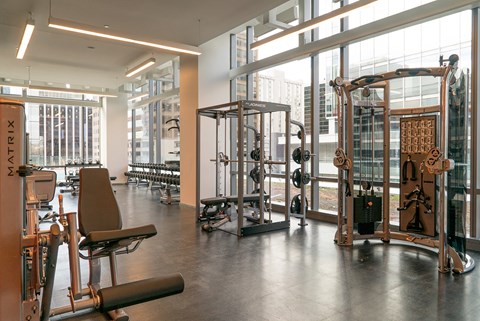 A gym with a variety of equipment including a leg press machine.