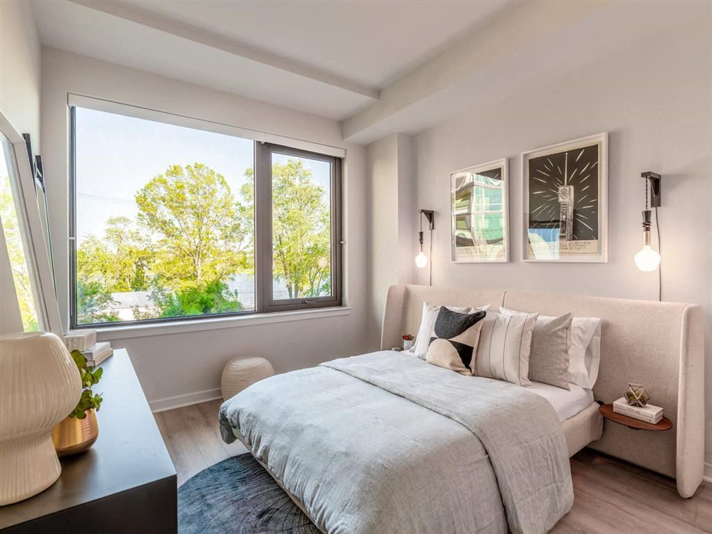 RiverPoint apartments in Washington, DC spacious bedroom with expansive windows allowing natural light