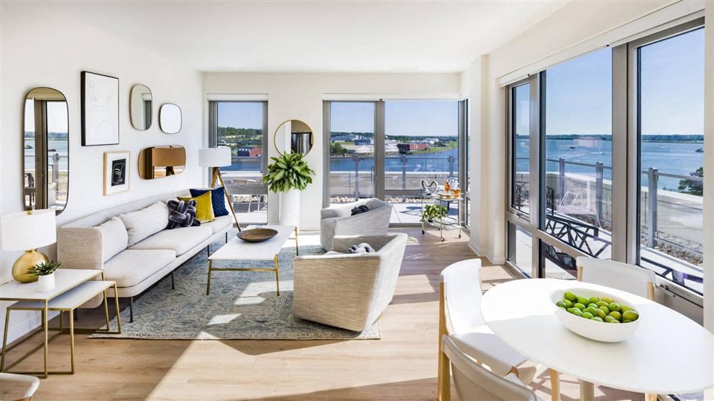 RiverPoint apartments penthouse living and dining areas with floor to ceiling windows and sweeping waterfront views