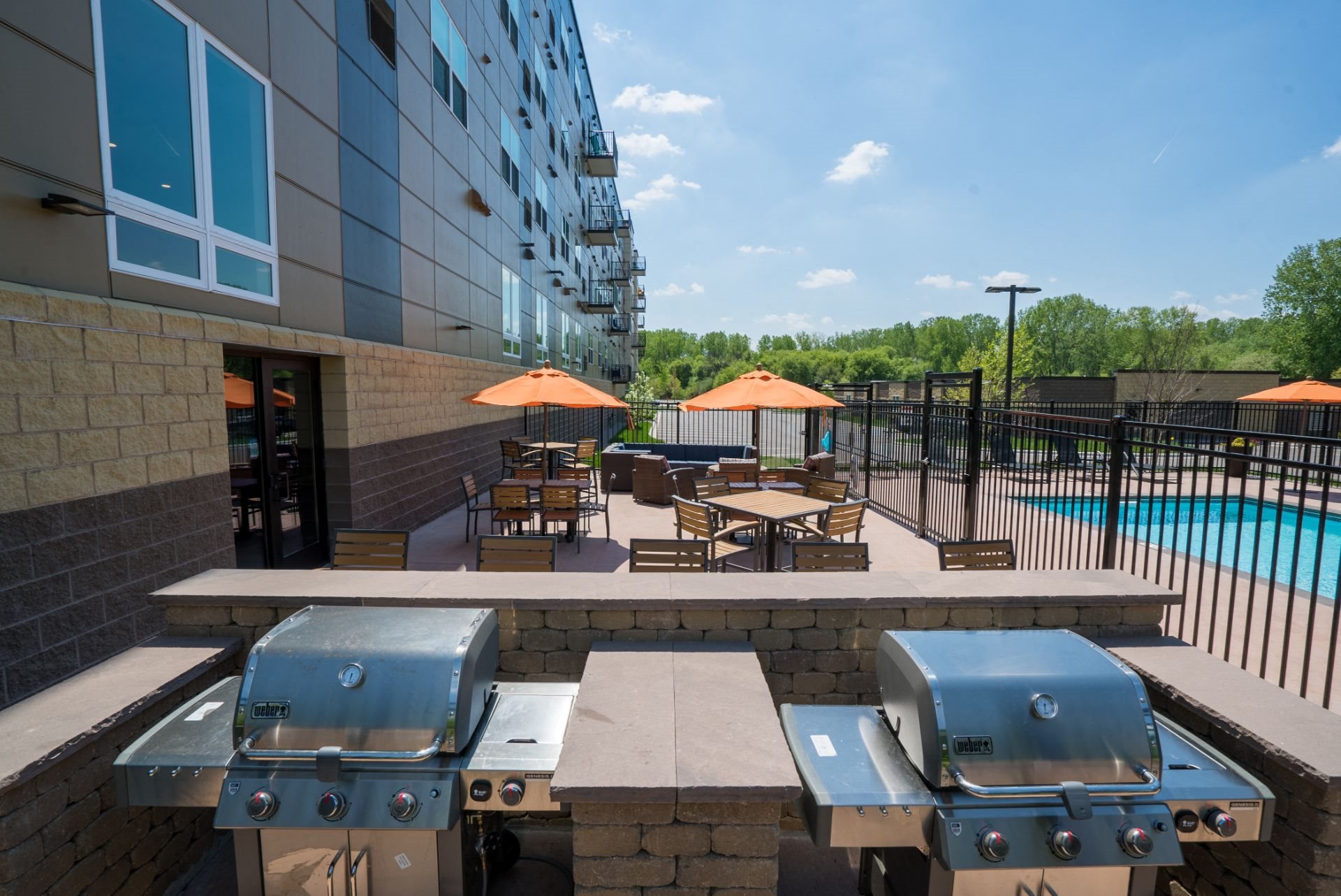 Amenities Poolside Outdoor Kitchen with Grilling Stations, Berkshire Central Apartments- 9436 Ulysses Street NE Blaine, MN. 55434
