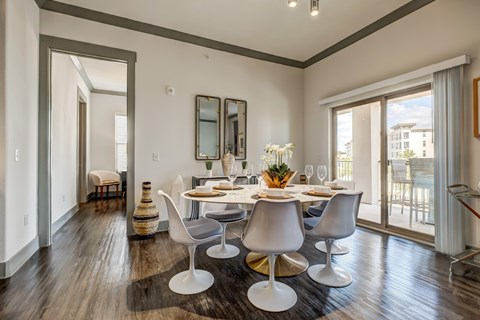 A dining room with a table set for six.
