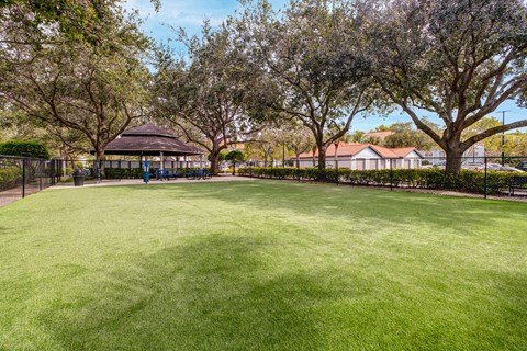 A park with a gazebo surrounded by trees.
