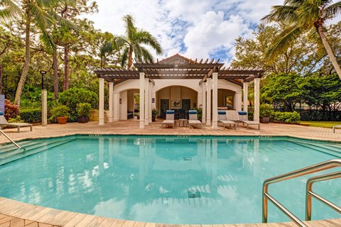 A pool with a building in the background.