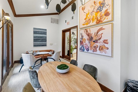 A dining room with a wooden table and chairs.