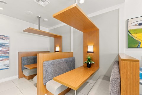A modern dining area with a wooden table and grey chairs.